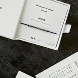 dark blue cord bracelet with oxidized Morse code beads — subtle gift for men, shown with gift card