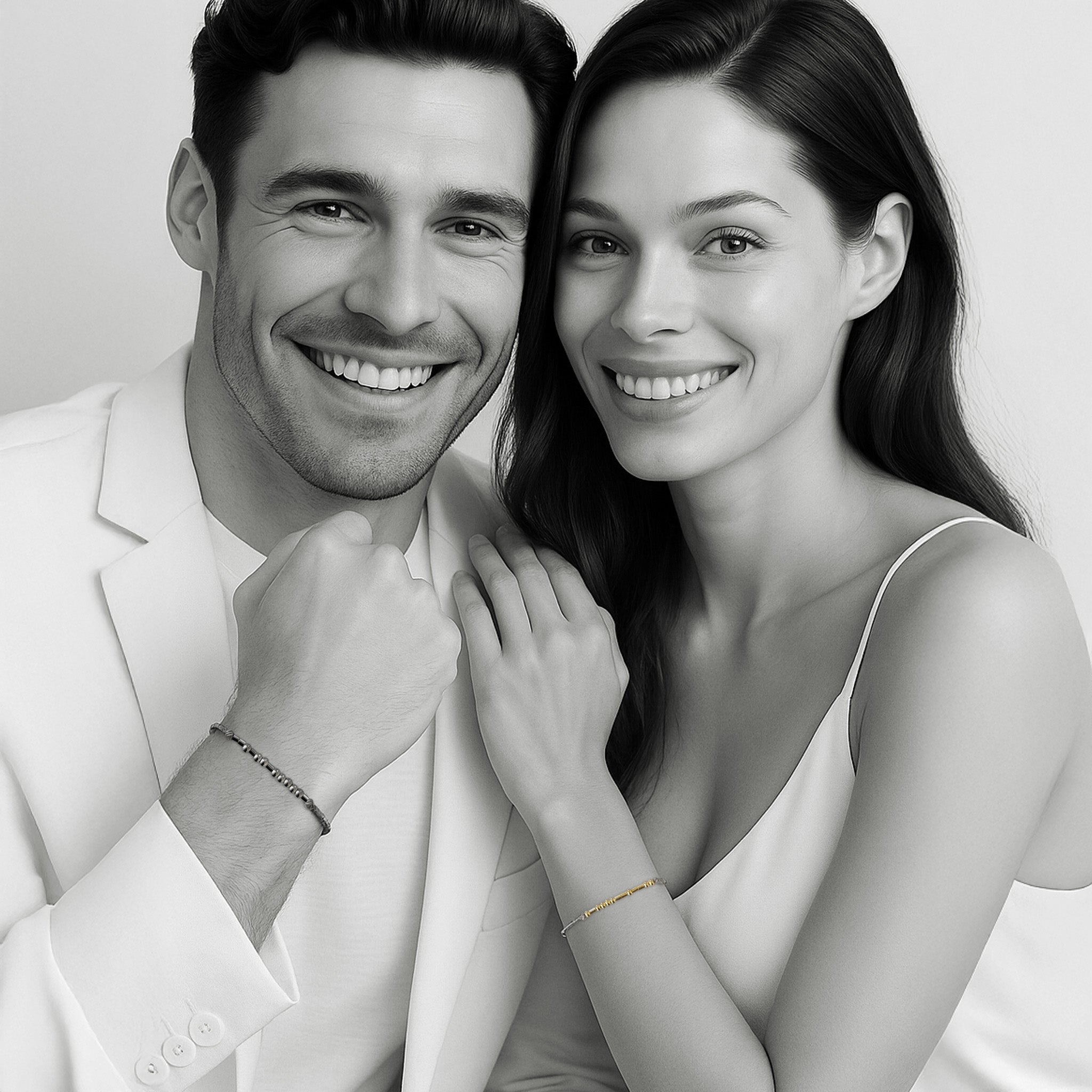 Couple wearing matching Morse code bracelets — woman in 18k gold and man in oxidized silver, minimal black-and-white editorial portrait by 143Code